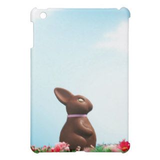 Chocolate Easter bunny amongst flowers in grass, iPad Mini Cases