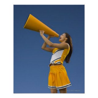 Female cheerleader shouting into megaphone poster