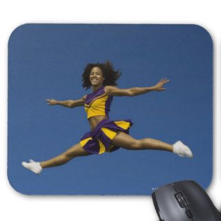 Female cheerleader doing jump splits in air mousepads
