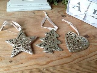 set of three gold christmas decorations by the hiding place