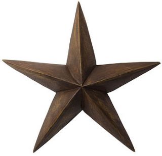 handcarved wooden barn star by the contemporary home