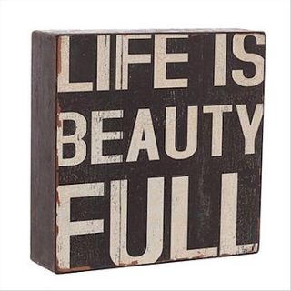 'life is beautiful' sign by little red heart