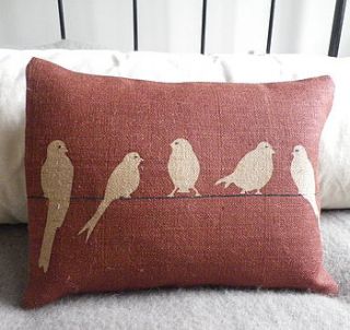 hand printed muted red bird on a wire cushion by helkatdesign
