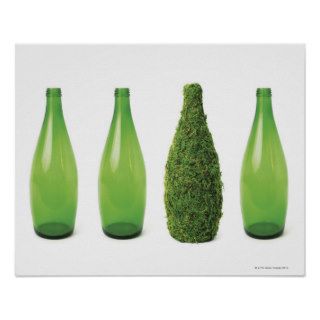 Green glass bottles showing recycling and posters