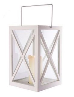 white wooden storm lantern by the contemporary home