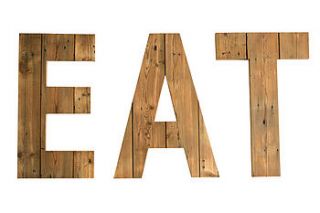 giant handmade reclaimed wooden 'eat' sign by ruby rhino
