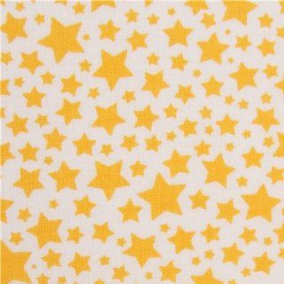 white Michael Miller fabric with many yellow stars (per 0.5 yard multiple)