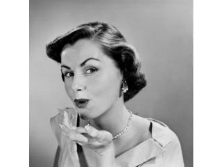 Studio portrait of young woman blowing kiss Poster Print (18 x 24)